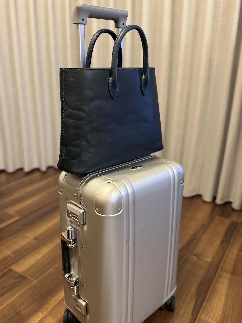 トートバッグをキャリーバッグに載せて
